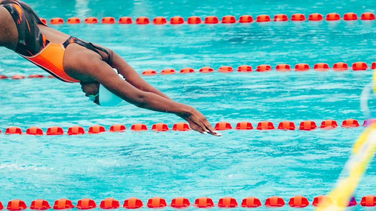 A swimmer takes a powerful dive into a pool during a competitive event in Lagos, Nigeria.