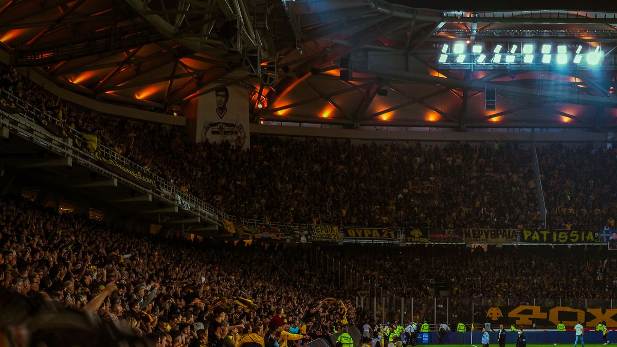 Exciting night soccer game with packed cheering fans and vibrant stadium lights.
