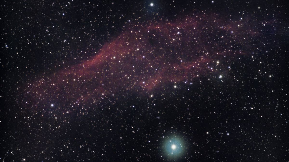 Explore the vibrant colors and stars of a cosmic nebula in deep space.