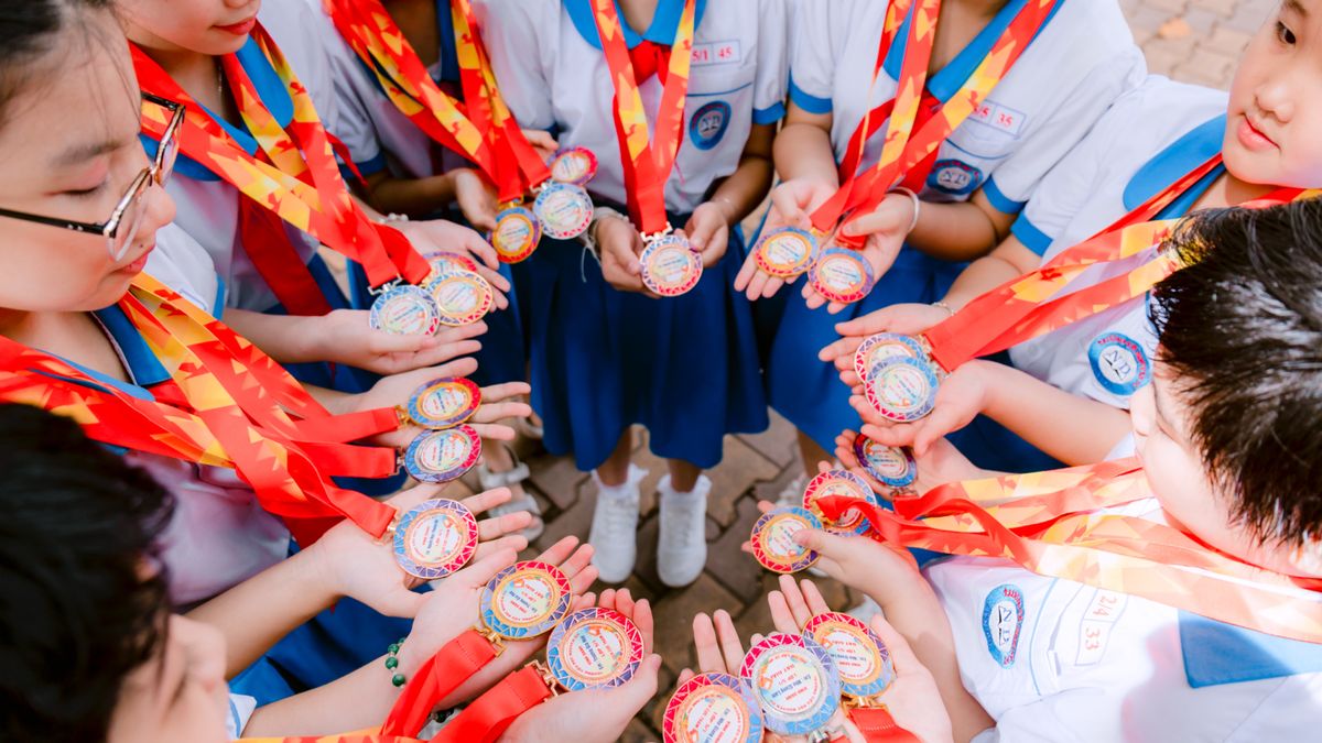 Young students proudly display medals, symbolizing achievement and teamwork.